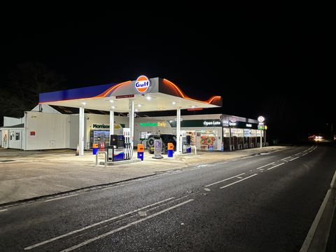 The Gulf forecourt and Morrisons Daily shop at Wivelsfield, lit up at night